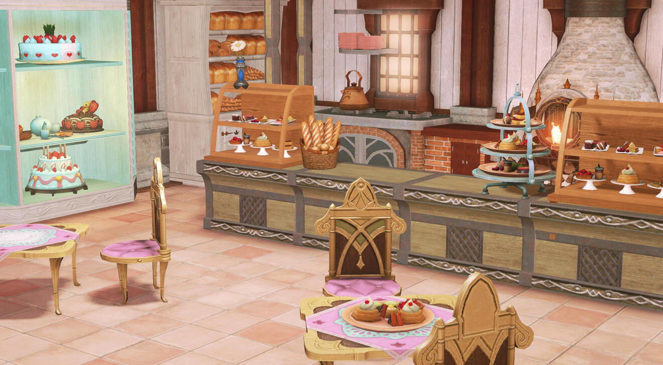 A view of the bakery from the doorway, with a couple of small tables laden with sweets, a counter with displays of pastries.